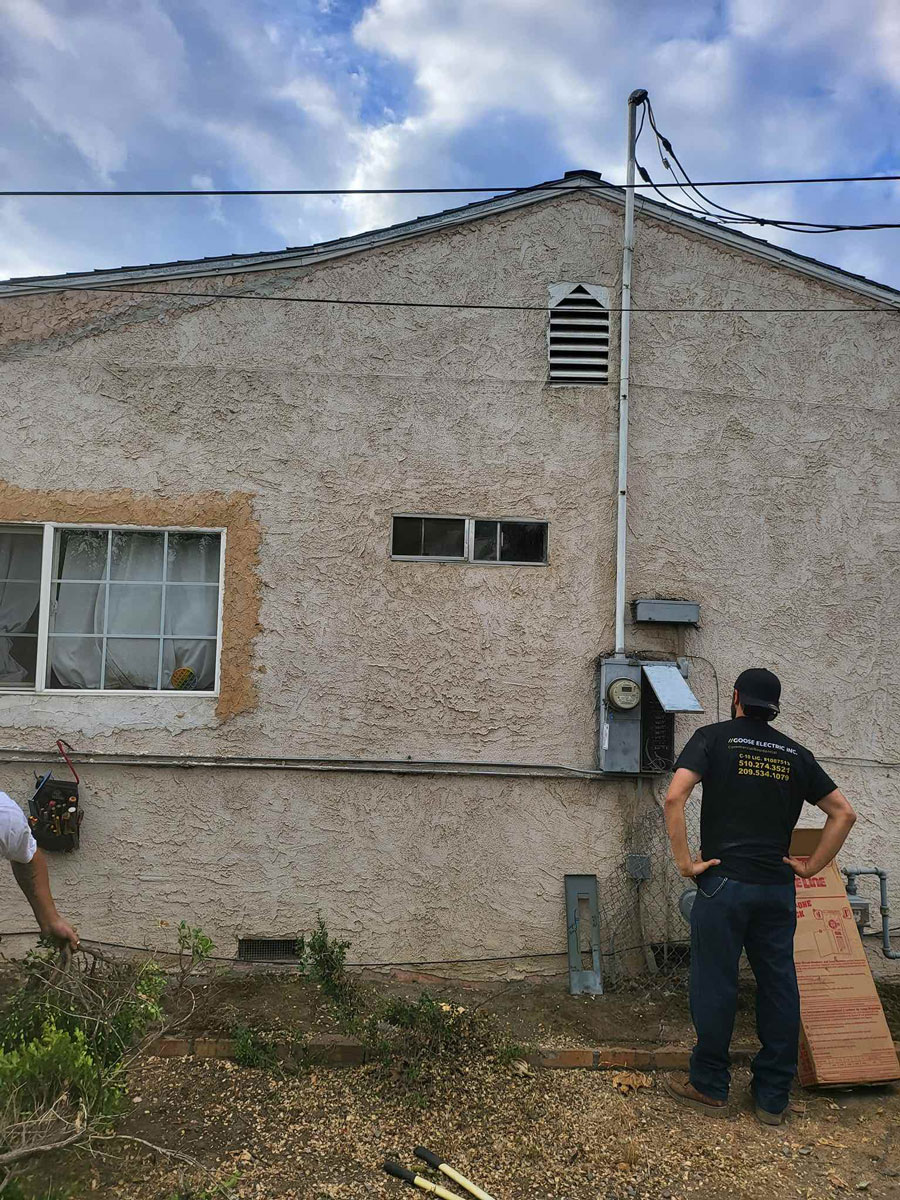 a person standing in front of a brick building