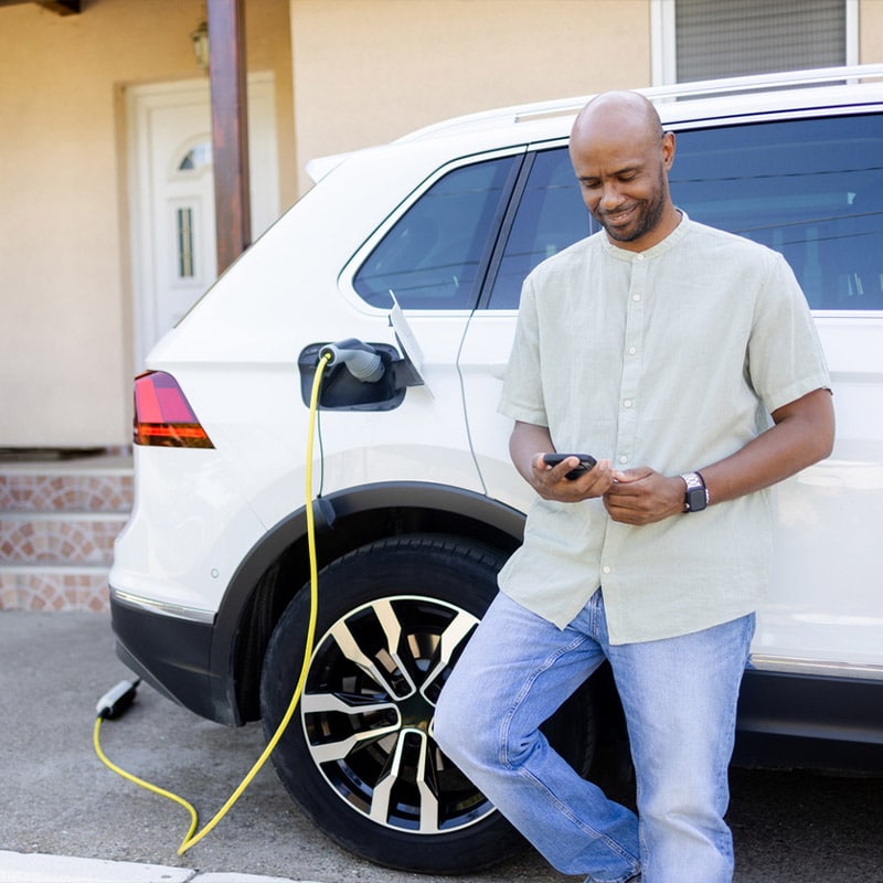 a person standing in front of a car